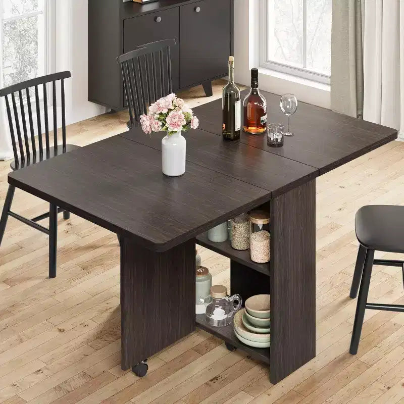 Table de salle à manger pliable et compacte pour 4 personnes avec abattant, 2 étagères de rangement et 6 roulettes pour une mobilité facile
