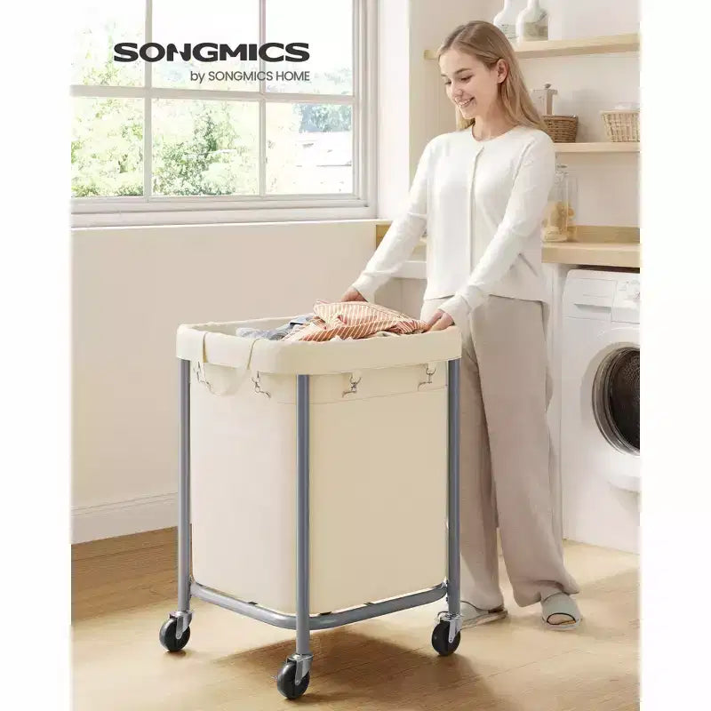 SONGMICS Panier à linge 170 L avec roues, cadre en acier et sac amovible, 2 roulettes verrouillables, blanc crème et argent métallique
